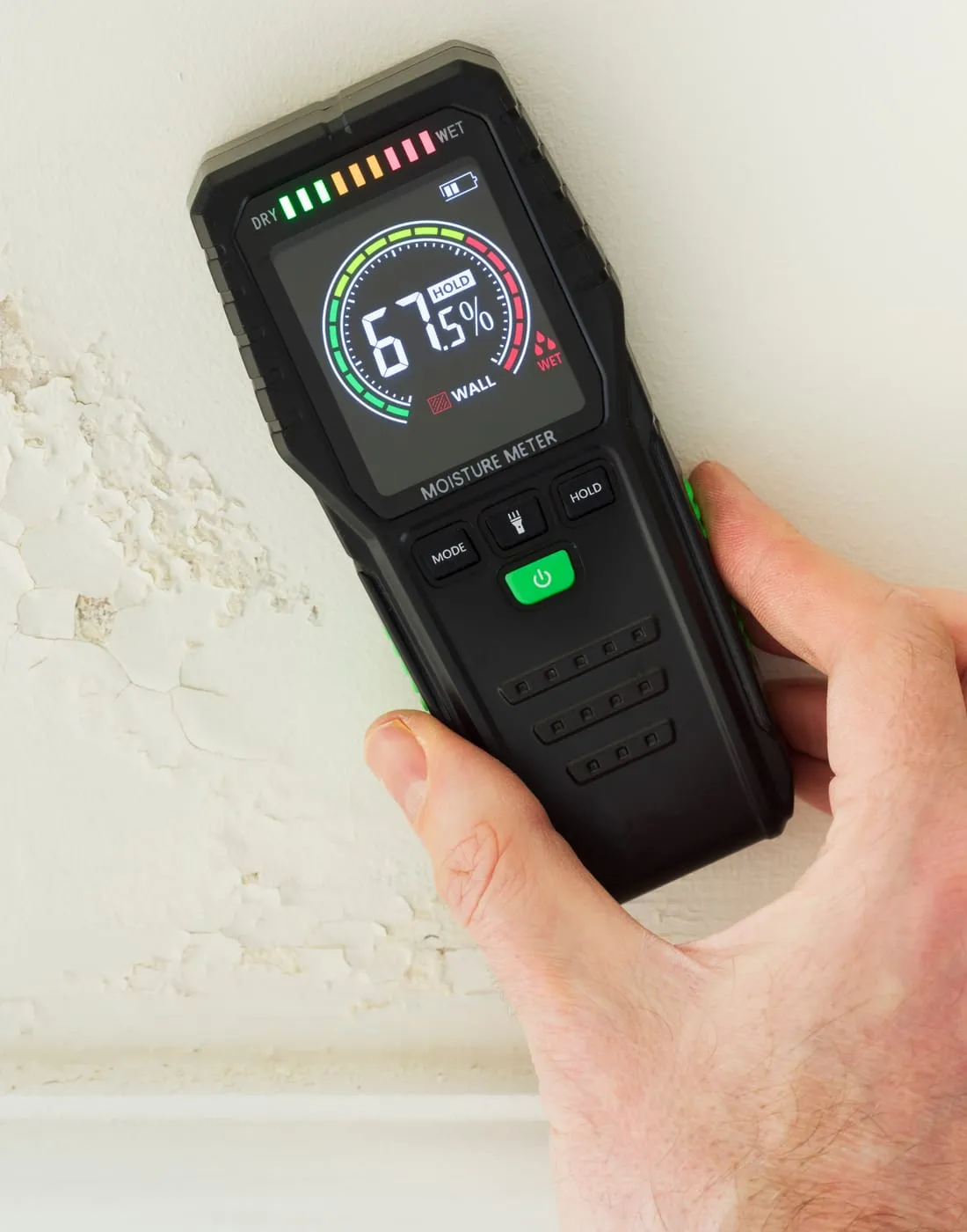 Damp specialist taking a moisture reading during a survey